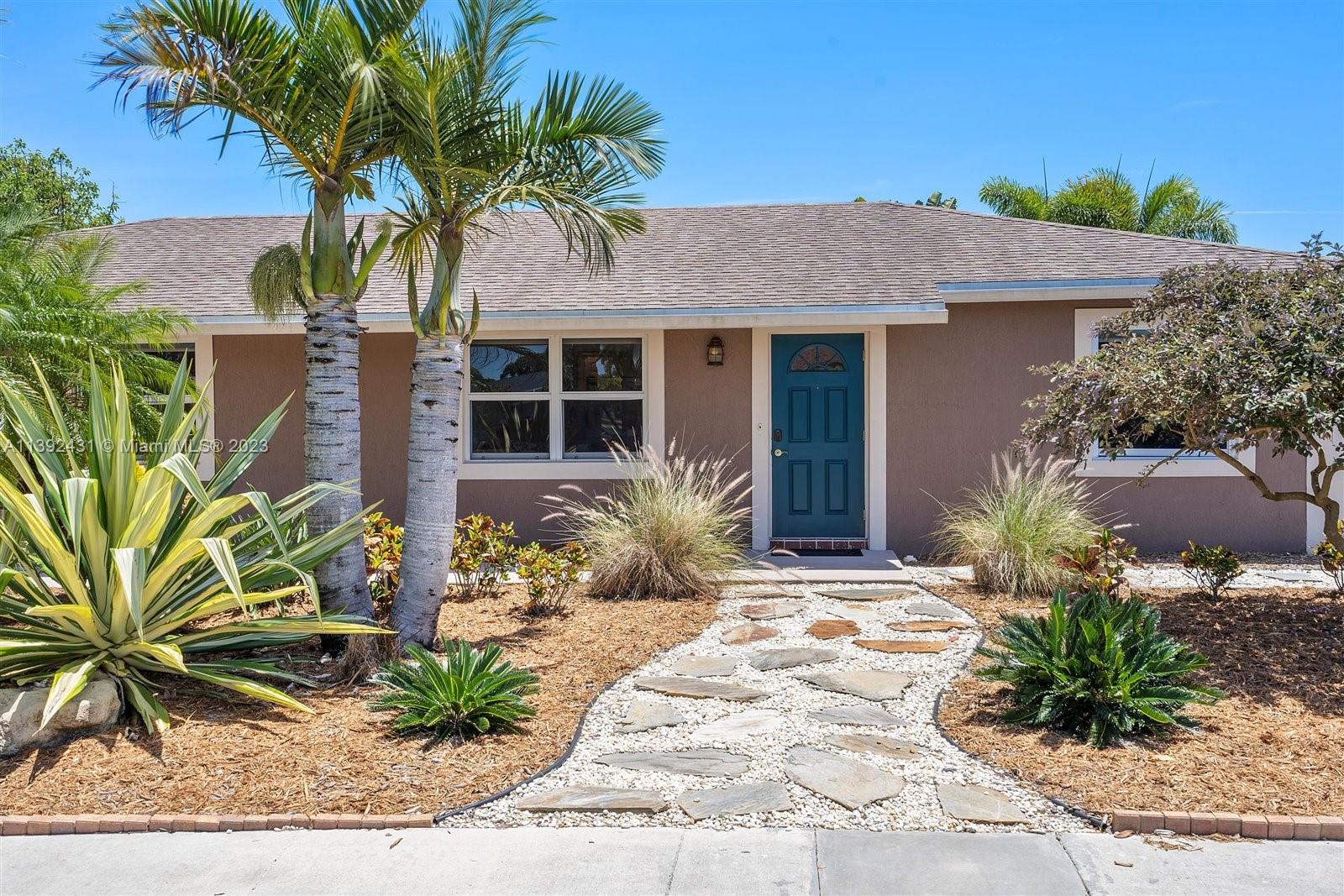 19404 Colorado Circle Boca Raton, FL 33434 - Photo 5 of 62 a view of a house with a small yard and potted plants