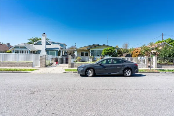 a view of a cars park in front of a building
