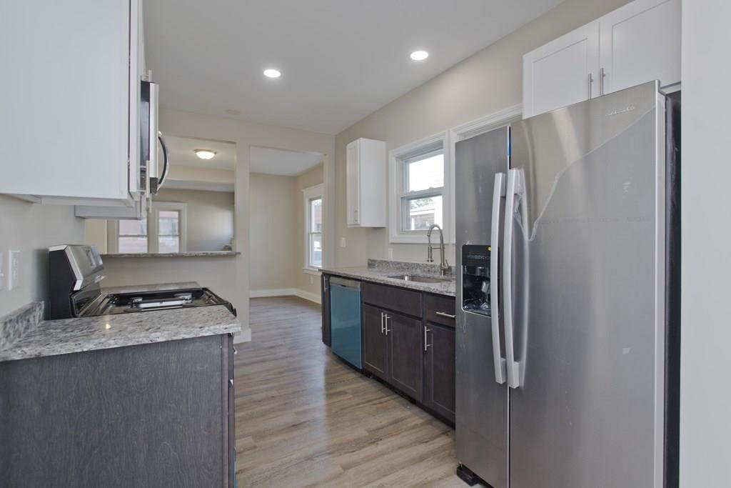 19 Judson Street Springfield, MA 01104 - Photo 8 of 42 a kitchen with stainless steel appliances granite countertop a refrigerator a sink and a stove