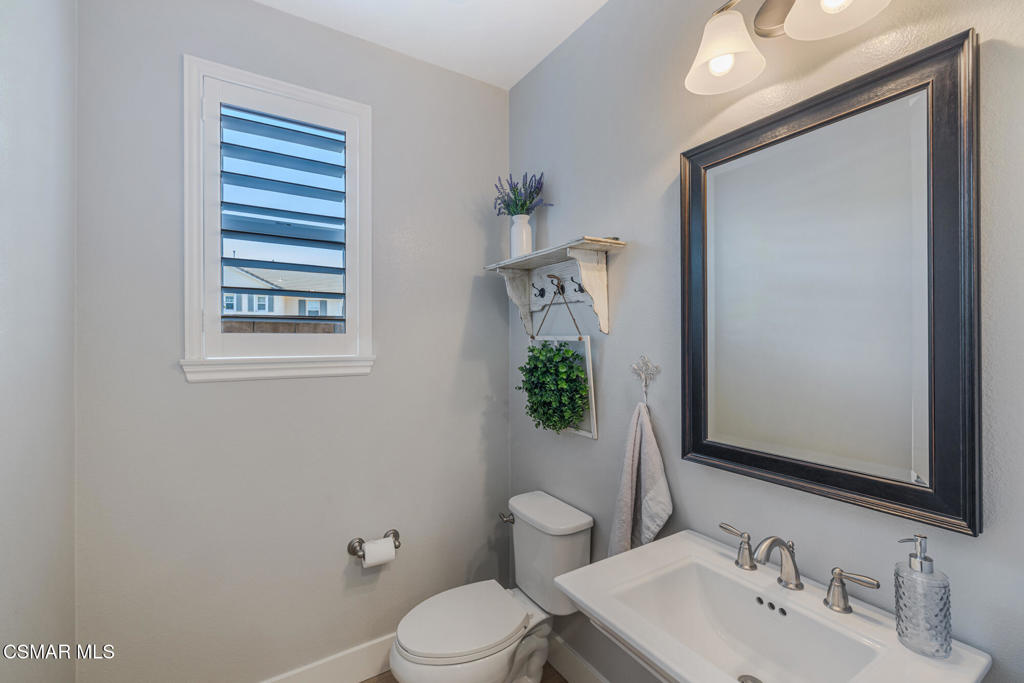13148 Bent Grass Place Moorpark, CA 93021 - Photo 12 of 76 a bathroom with a toilet a sink and mirror