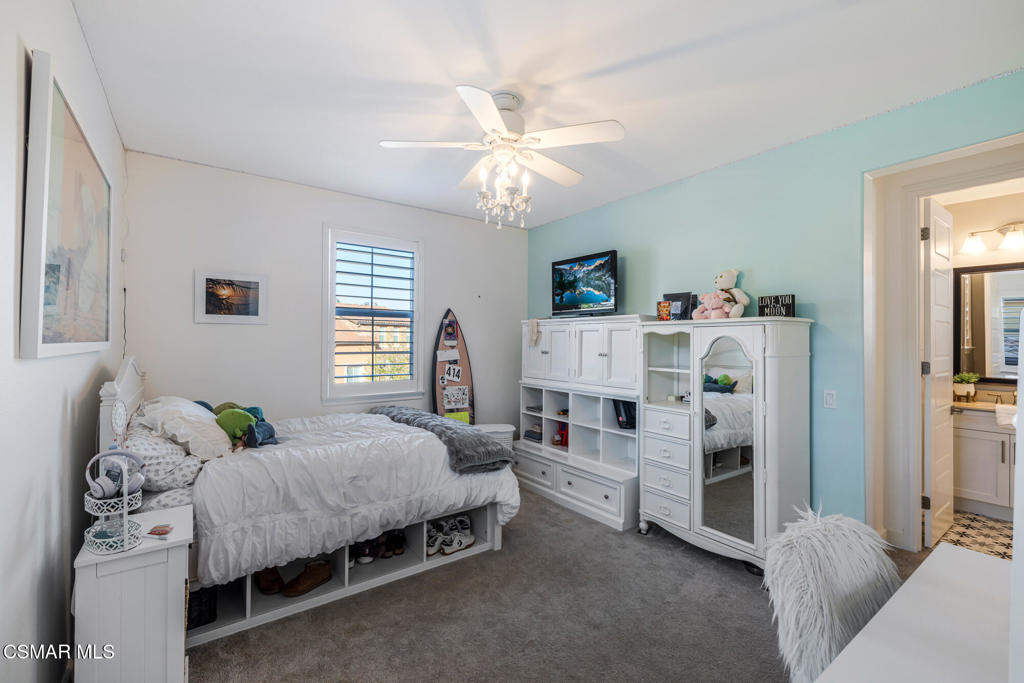 13148 Bent Grass Place Moorpark, CA 93021 - Photo 27 of 76 a bedroom with a bed and a chandelier