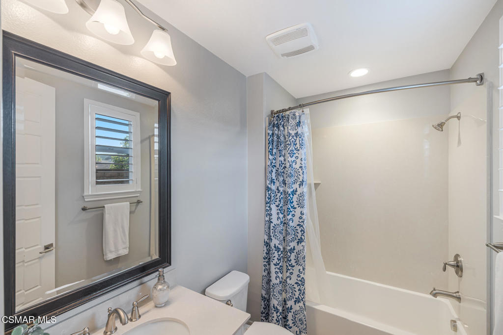 13148 Bent Grass Place Moorpark, CA 93021 - Photo 35 of 76 a bathroom with a shower curtain and a sink