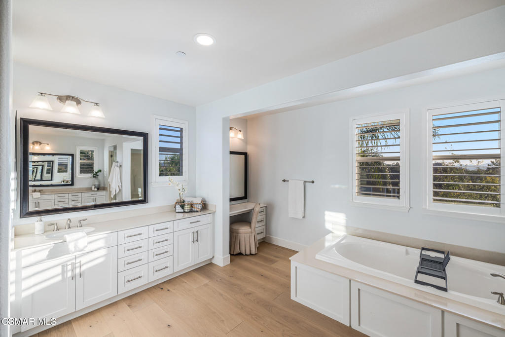 13148 Bent Grass Place Moorpark, CA 93021 - Photo 42 of 76 a spacious bathroom with stainless steel appliances a double vanity sink a window and a bathtub