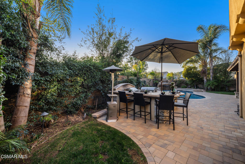 13148 Bent Grass Place Moorpark, CA 93021 - Photo 55 of 76 a view of a tables and chairs under an umbrella in backyard
