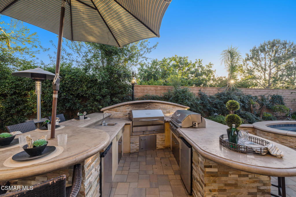 13148 Bent Grass Place Moorpark, CA 93021 - Photo 56 of 76 a view of a patio with table and chairs under an umbrella