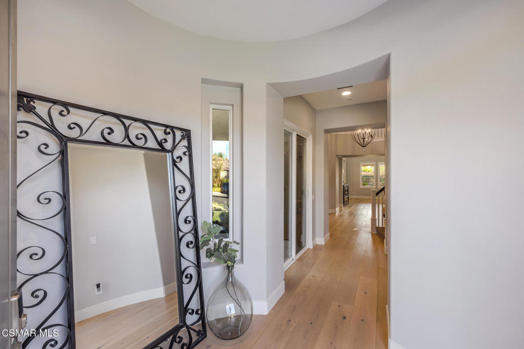 13148 Bent Grass Place Moorpark, CA 93021 - Photo 7 of 76 a view of a hallway with wooden floor and stairs