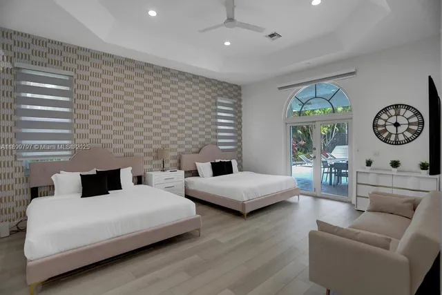 a bedroom with two beds and a window