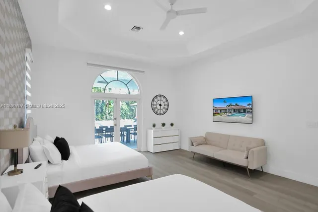 a bedroom with two beds and a chandelier