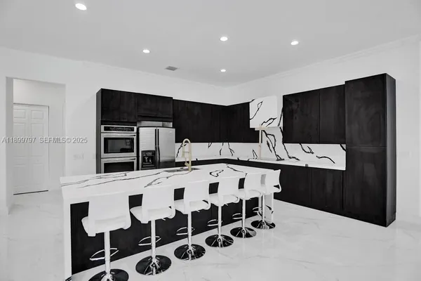 a kitchen with a dining table and chairs