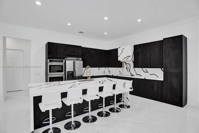 a kitchen with a dining table and chairs