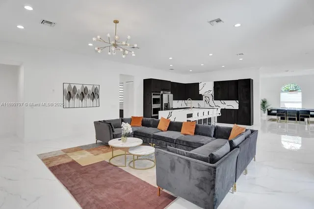 an aerial view of residential houses with outdoor space and trees