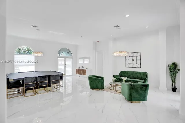 an aerial view of a house with a yard swimming pool patio and outdoor seating