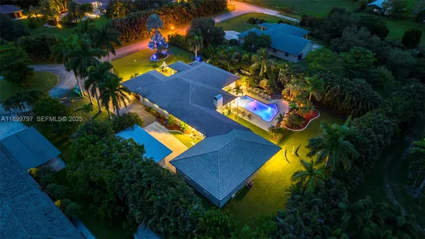 a view of an house with swimming pool and sitting area