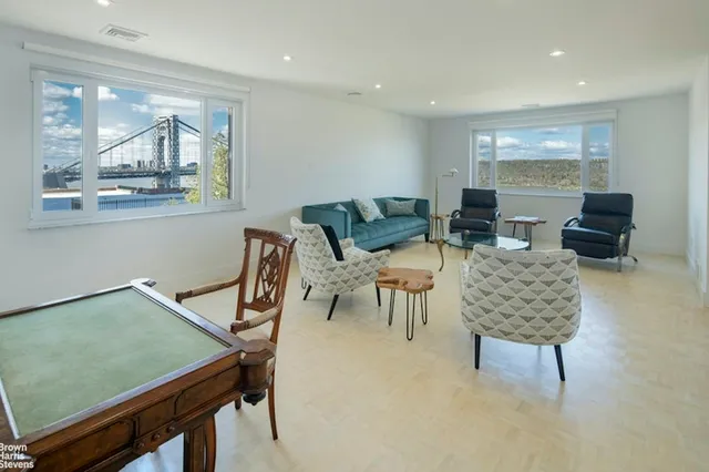 a city street lined with parked cars and buildings