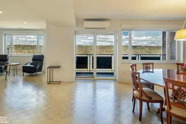 a dining room with furniture a chandelier and wooden floor