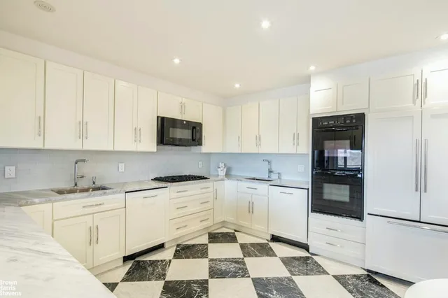 a kitchen with granite countertop appliances cabinets and furniture