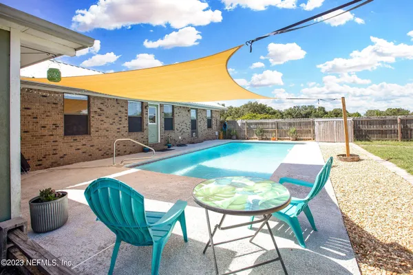 a view of a chairs and table in the patio