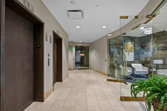 a view of a hallway with seating space