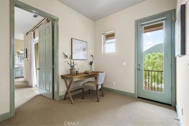 a view of a room with a table and chairs