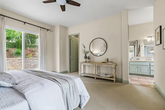 a bed room with a bed mirror and a window