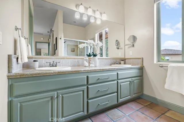a bathroom with a double vanity sink and a mirror