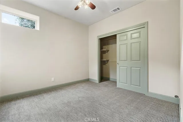 an empty room with windows and closet