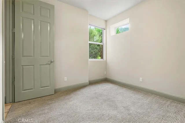 a bathroom with a granite countertop sink a toilet and a large mirror