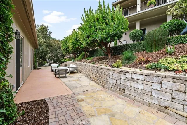 a front view of a house with a garden and plants
