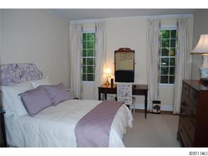 1146 Andover Road Charlotte, NC 28211 - Photo 13 of 13 a bedroom with a bed a table and chair