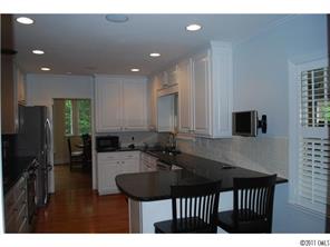 1146 Andover Road Charlotte, NC 28211 - Photo 7 of 13 a kitchen with kitchen island a sink stainless steel appliances and cabinets