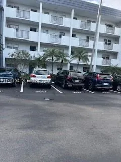 a view of a cars park in front of a building
