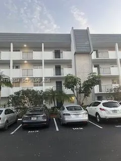 a couple of cars parked in front of a house