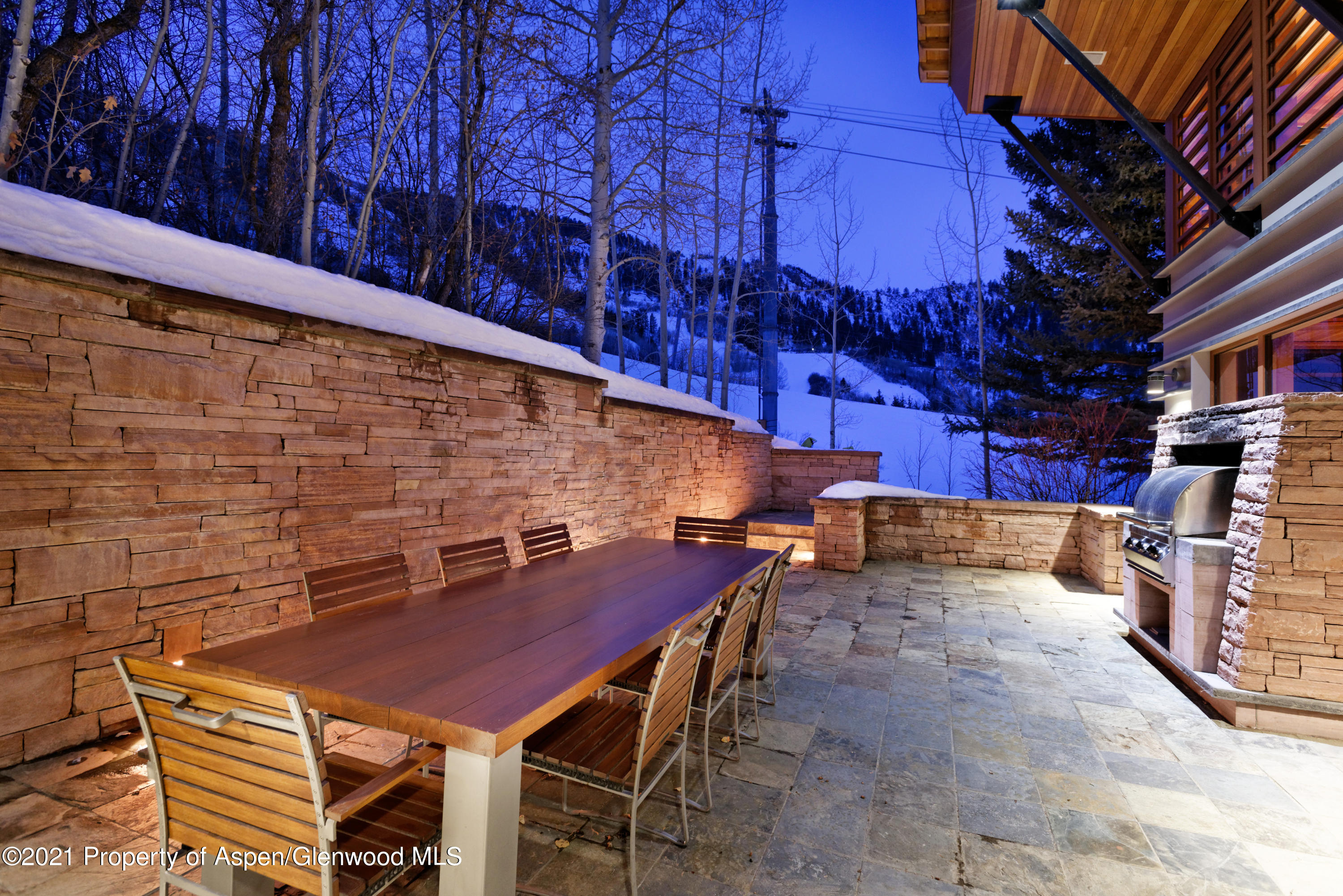 550 Aspen Alps Road South Aspen, CO 81611 - Photo 25 of 58 a view of a patio with a table and chairs