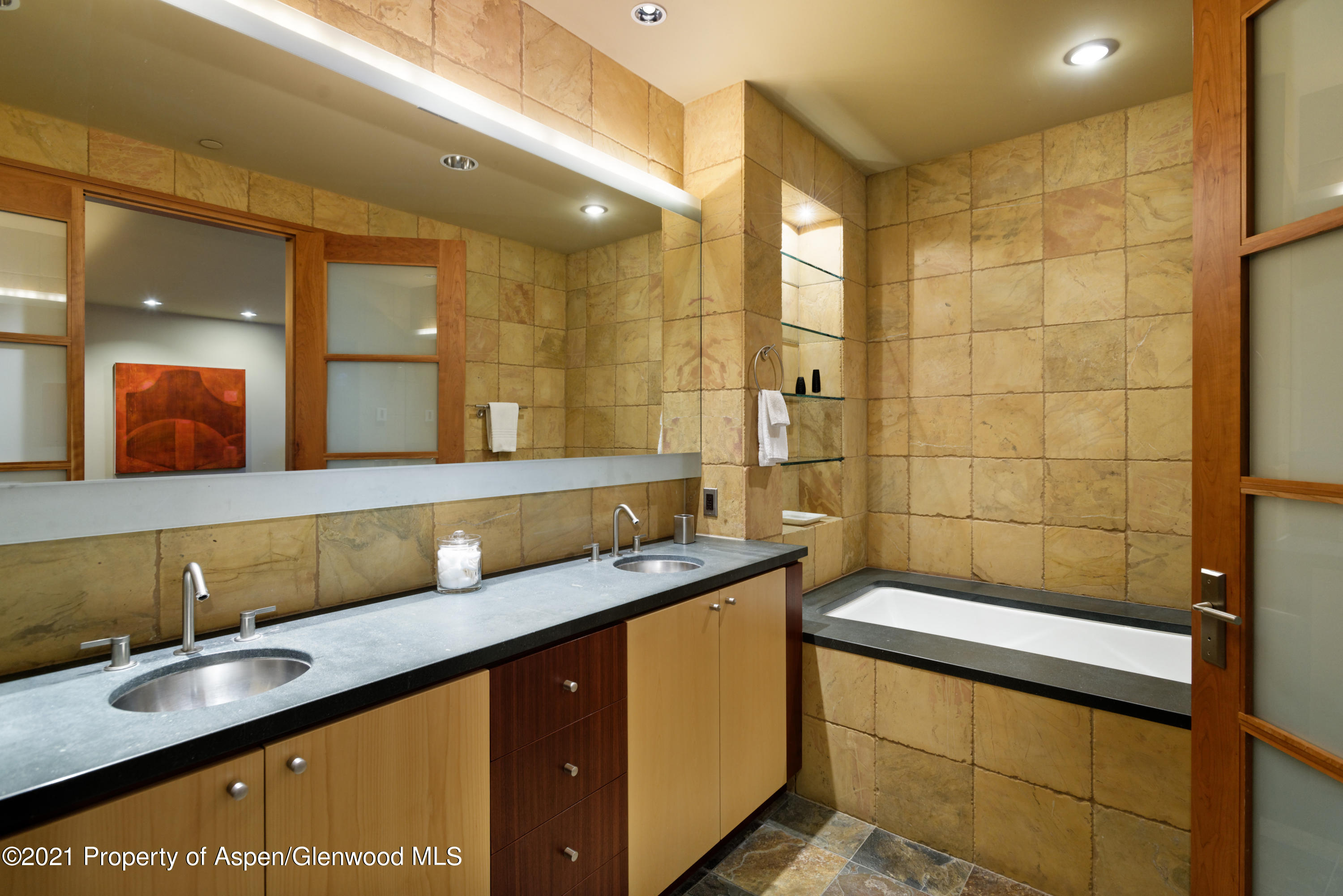 550 Aspen Alps Road South Aspen, CO 81611 - Photo 47 of 58 a bathroom with a granite countertop sink a mirror and a shower