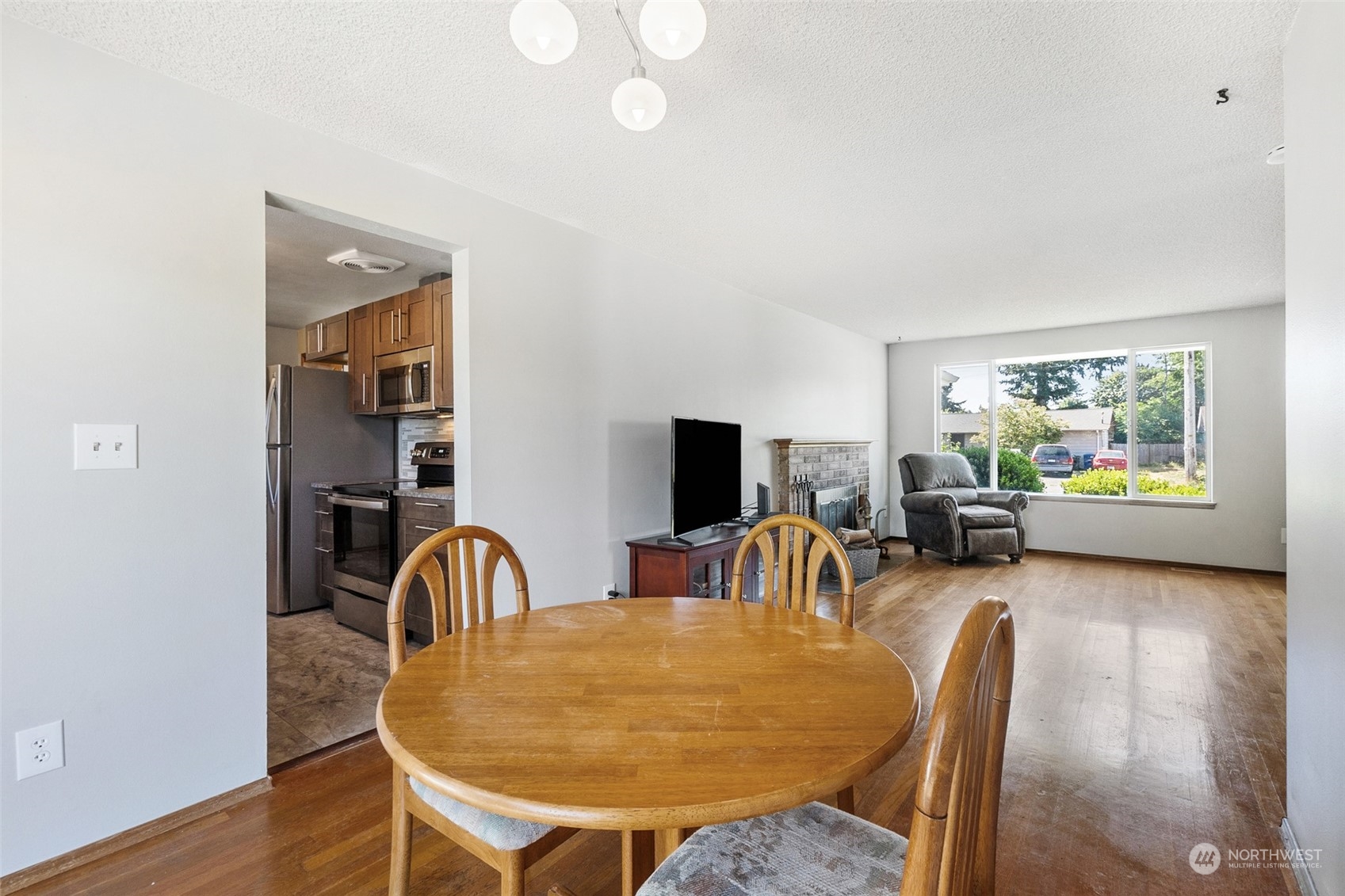 3640 Northeast 10th Street Renton, WA 98056 - Photo 10 of 19 a view of a dining room with furniture and wooden floor