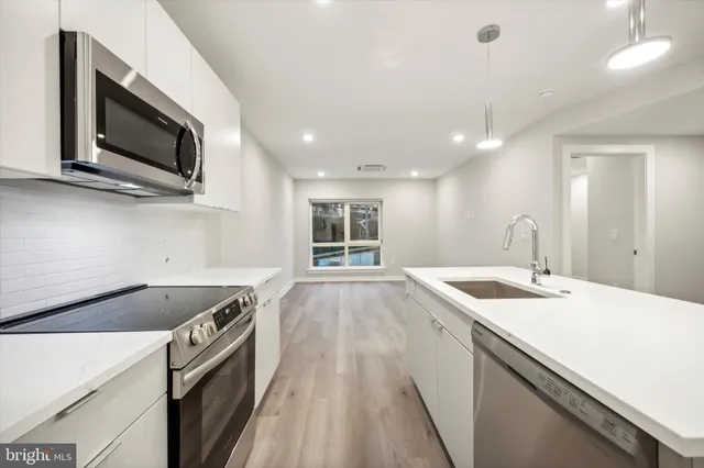 a kitchen with a sink and a microwave