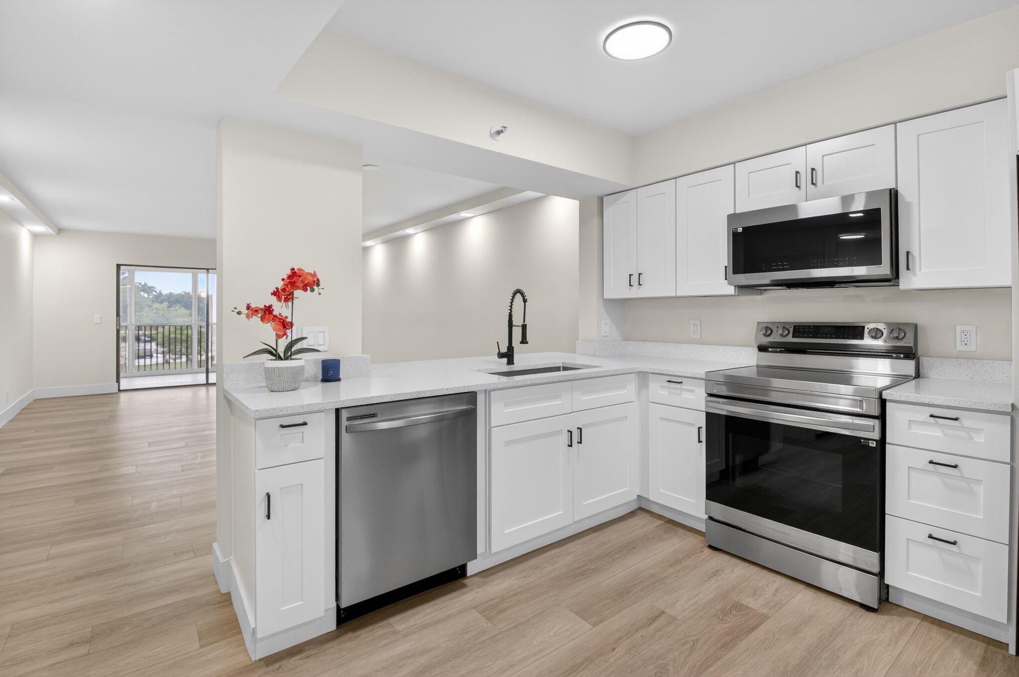 a kitchen with a sink stove and microwave