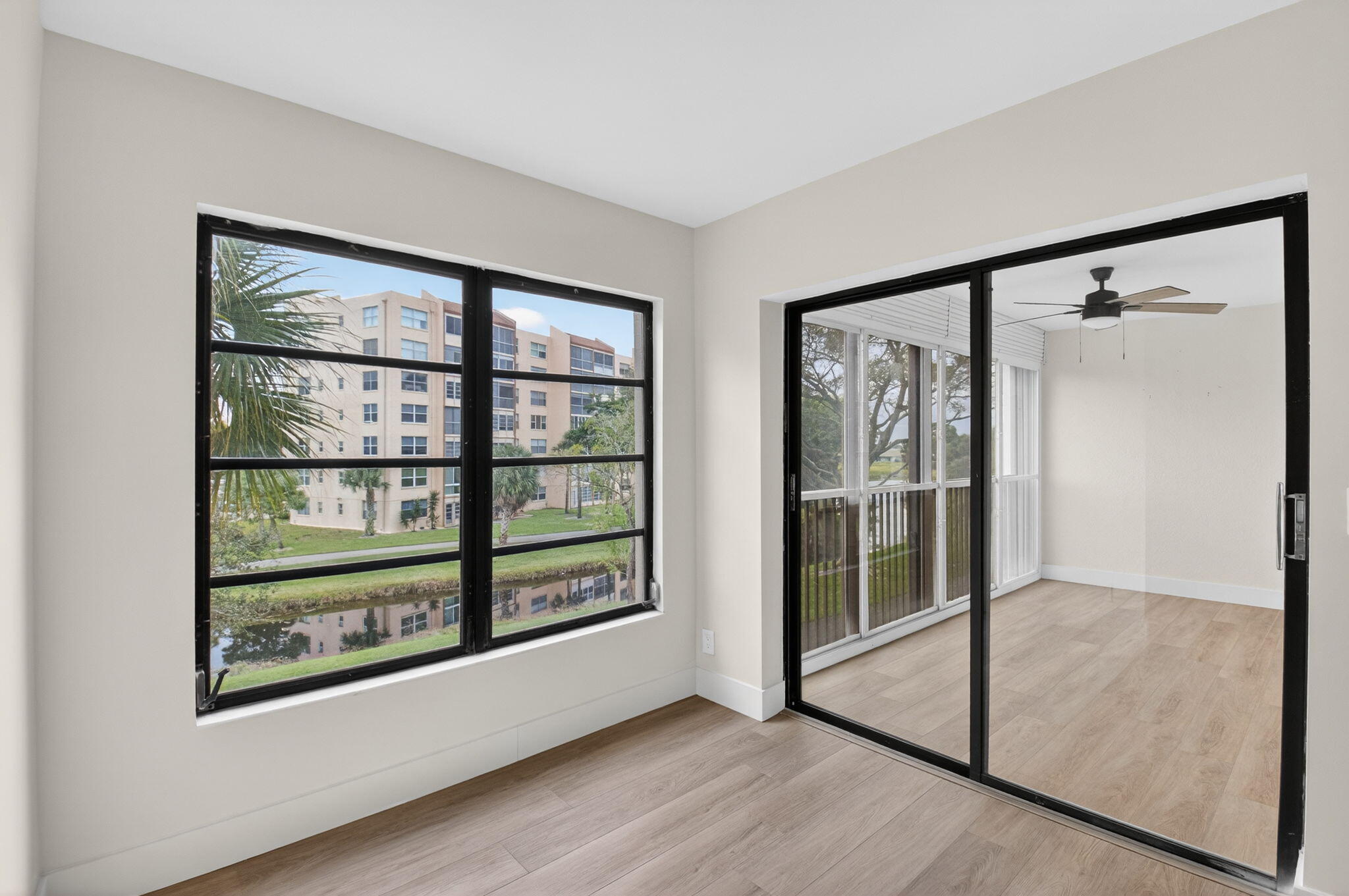 14475 Strathmore Lane, Unit 305 Delray Beach, FL 33446 - Photo 13 of 27 a view of a big room with wooden floor and windows