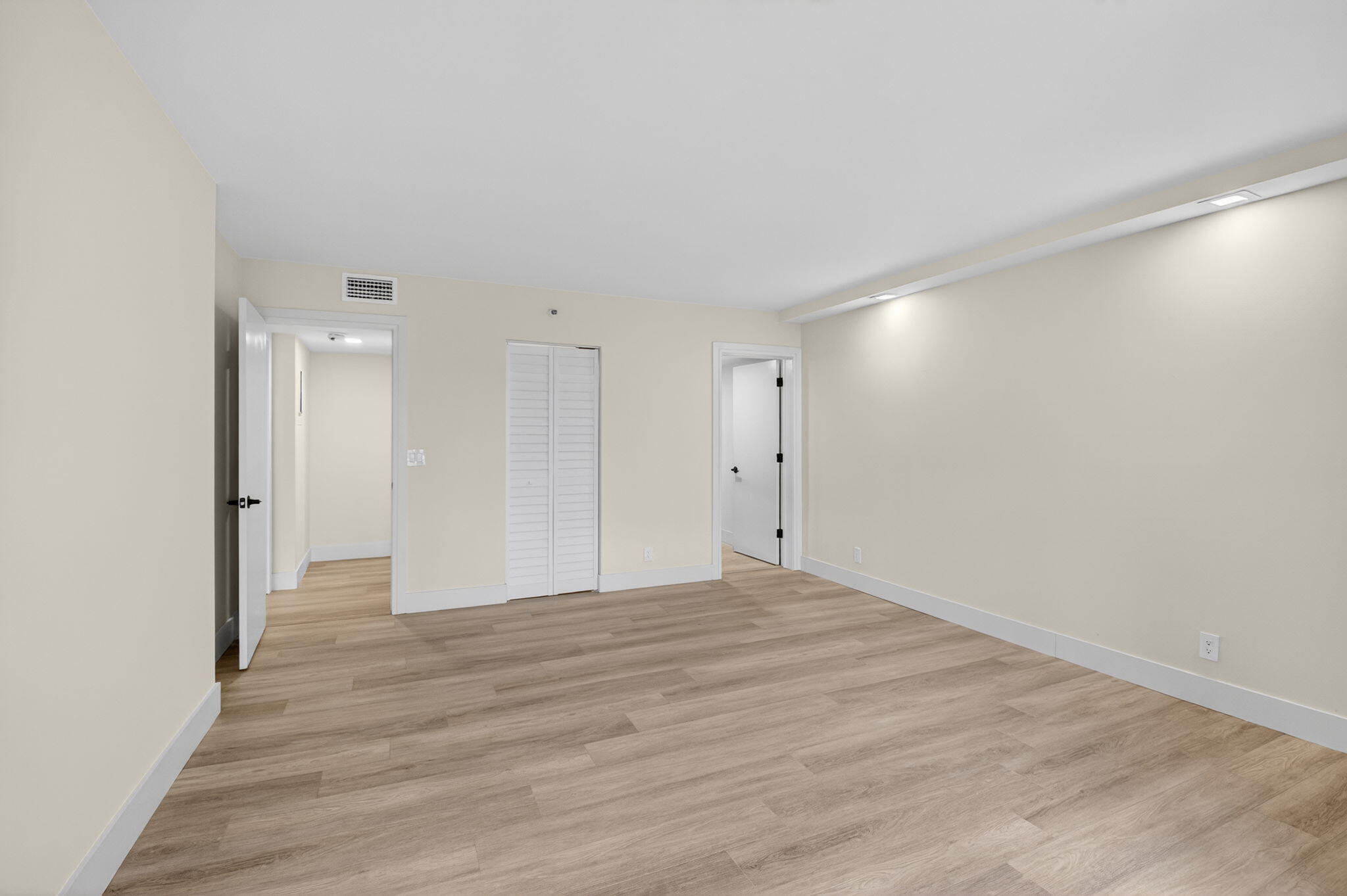 14475 Strathmore Lane, Unit 305 Delray Beach, FL 33446 - Photo 14 of 27 a view of an empty room and wooden floor
