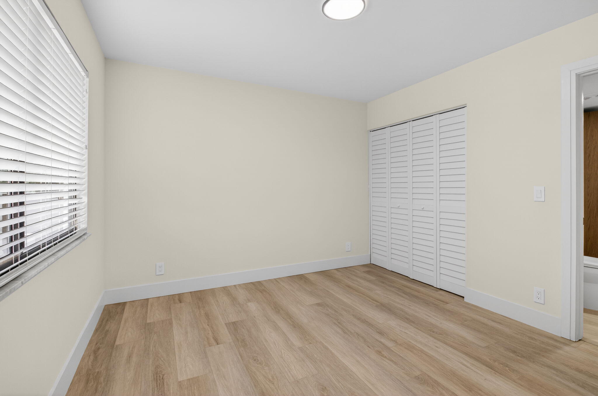 14475 Strathmore Lane, Unit 305 Delray Beach, FL 33446 - Photo 21 of 27 wooden floor in an empty room with a window