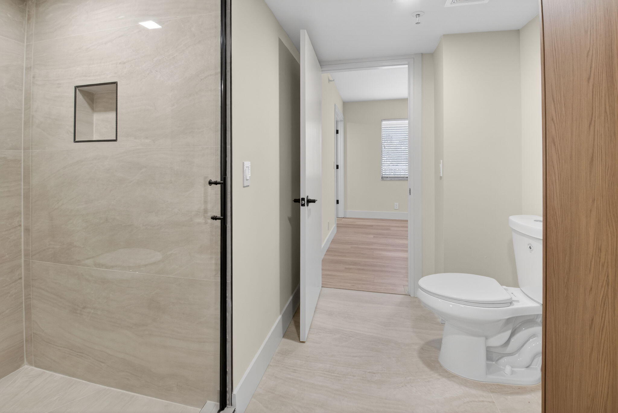 14475 Strathmore Lane, Unit 305 Delray Beach, FL 33446 - Photo 23 of 27 a bathroom with a toilet and a shower