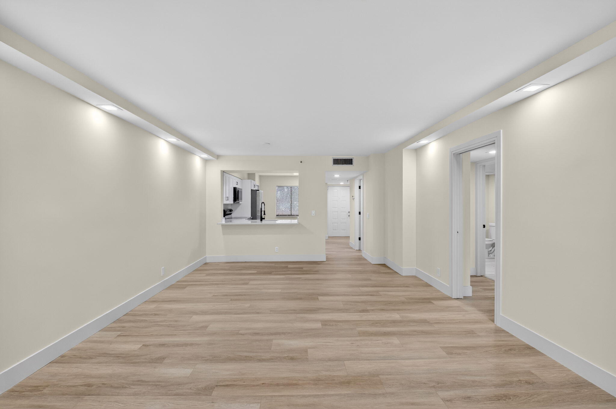 14475 Strathmore Lane, Unit 305 Delray Beach, FL 33446 - Photo 8 of 27 a view of a big room with wooden floor and windows