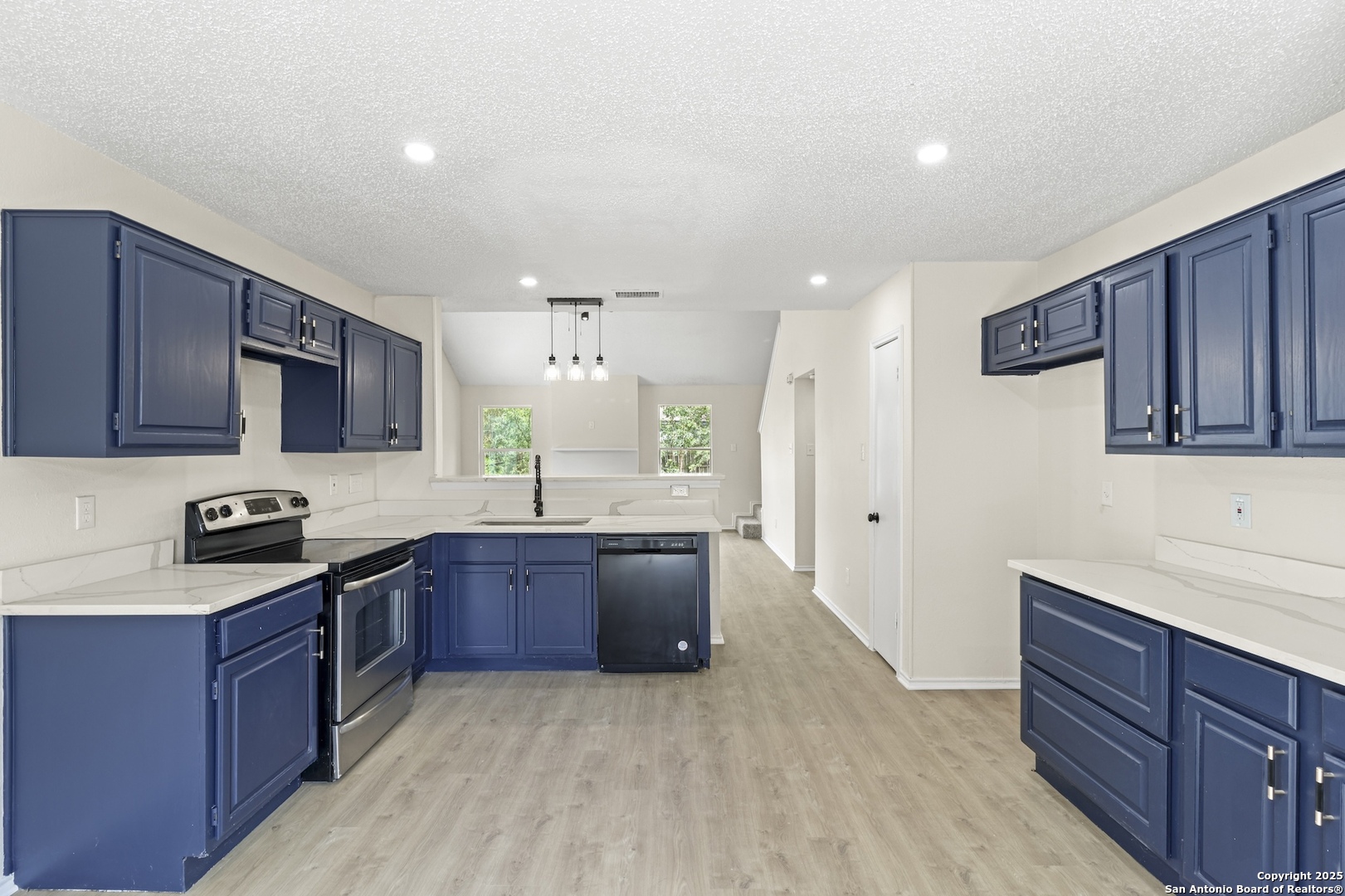 6403 Gray Ridge San Antonio, TX 78233 - Photo 11 of 50 a kitchen with stainless steel appliances granite countertop wooden cabinets a stove top oven a sink and dishwasher