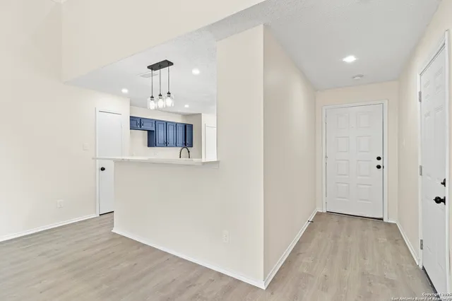 a view of a kitchen from the hallway