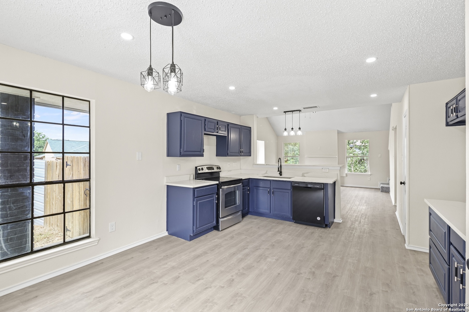 6403 Gray Ridge San Antonio, TX 78233 - Photo 23 of 50 a open kitchen with stainless steel appliances granite countertop a refrigerator a sink dishwasher a stove with wooden cabinets and floor