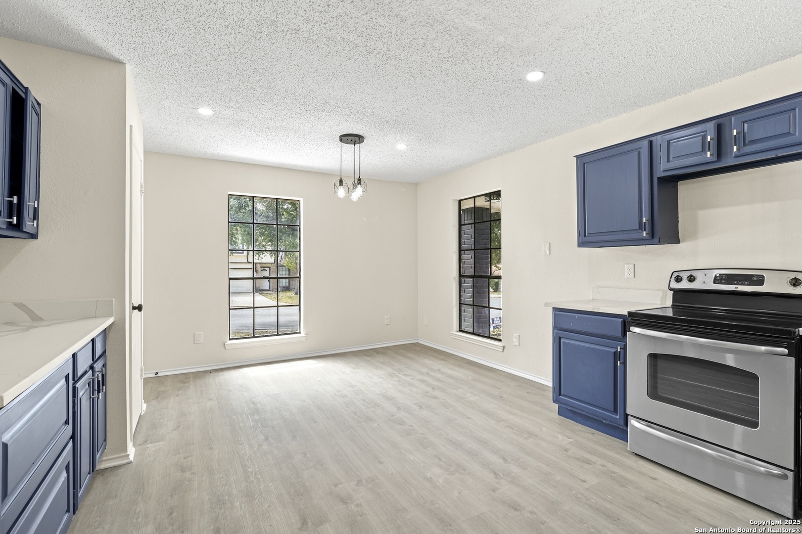 6403 Gray Ridge San Antonio, TX 78233 - Photo 25 of 50 a view of an empty room with a kitchen and a window