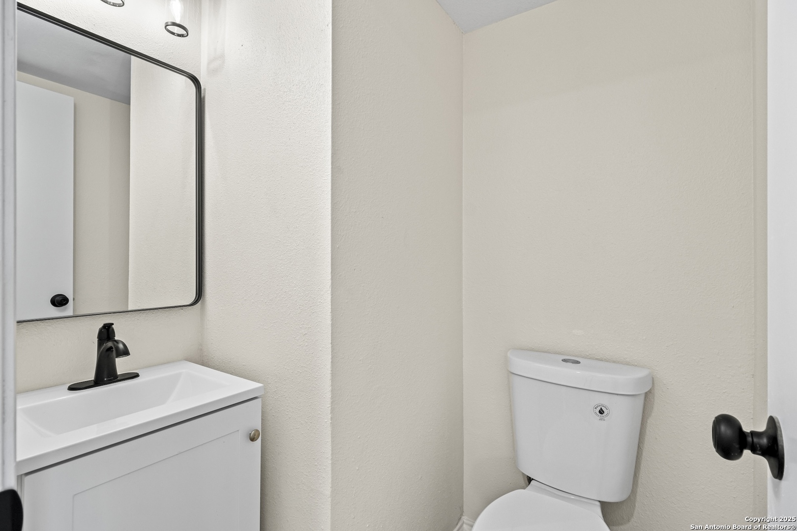 6403 Gray Ridge San Antonio, TX 78233 - Photo 27 of 50 a bathroom with a toilet sink and mirror