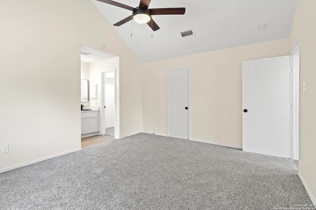a view of a big room with chandelier fan and closet