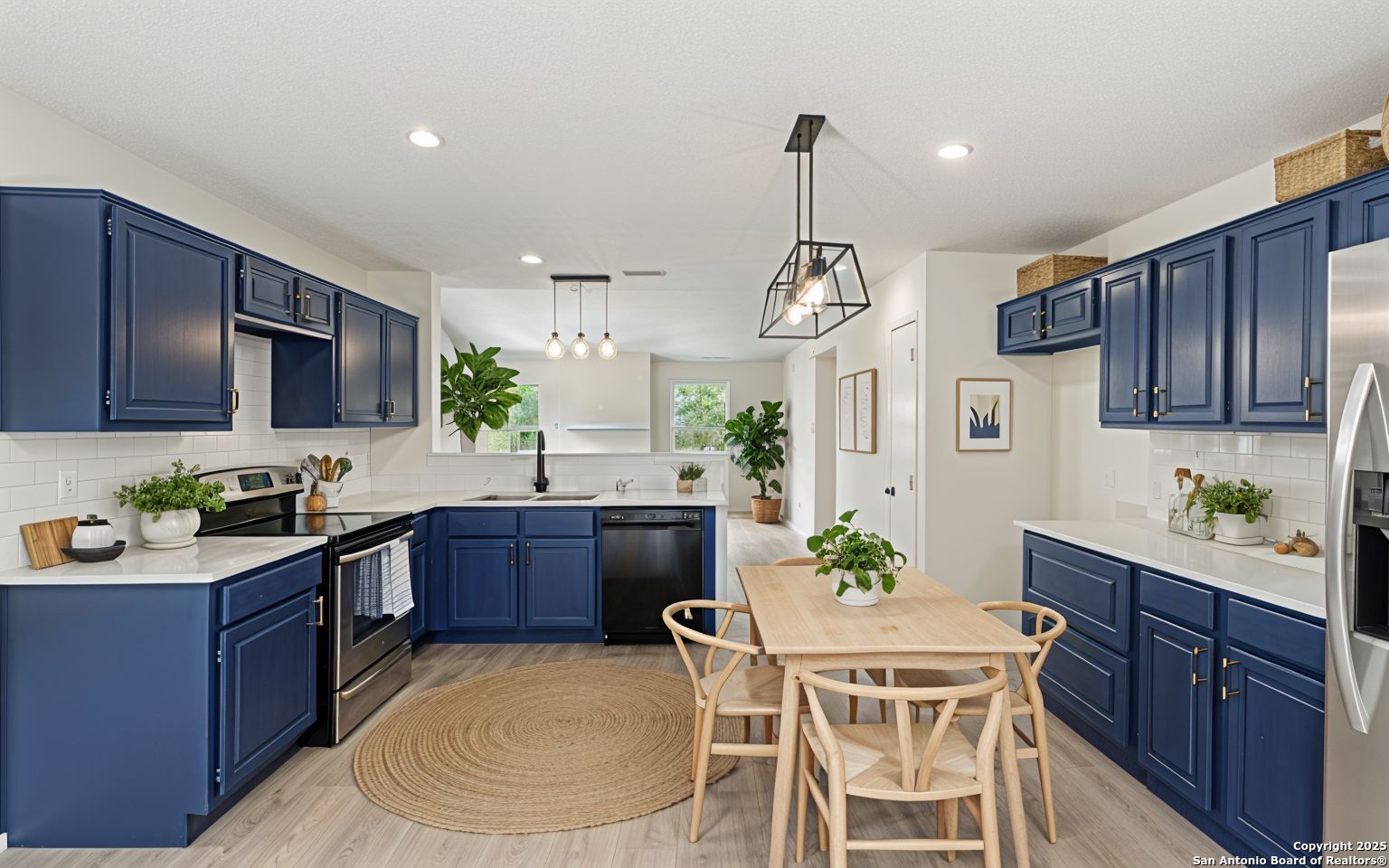 6403 Gray Ridge San Antonio, TX 78233 - Photo 3 of 50 a kitchen with a table chairs stove and cabinets