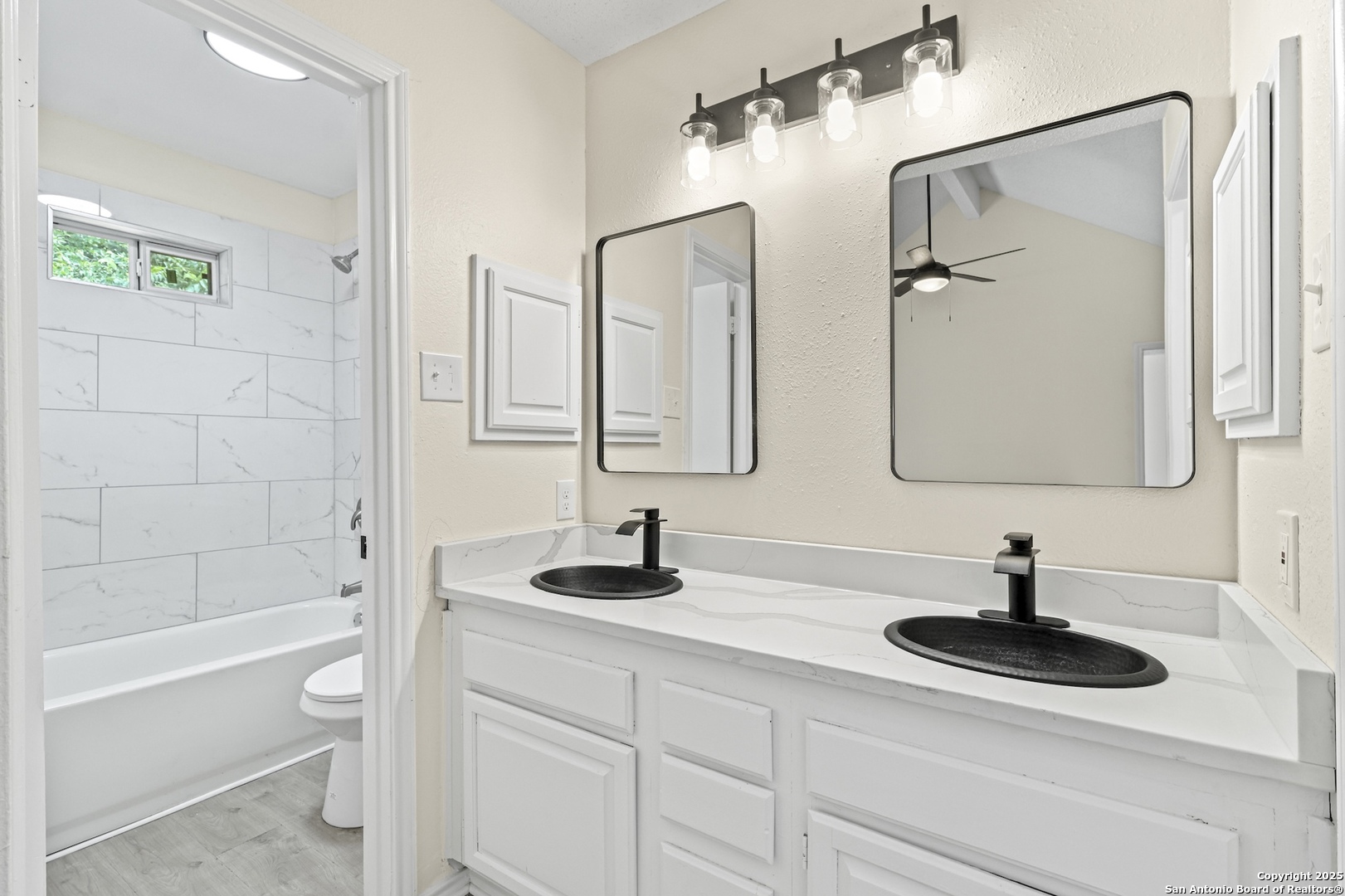 6403 Gray Ridge San Antonio, TX 78233 - Photo 33 of 50 a bathroom with a double sink double vanity and a bathtub